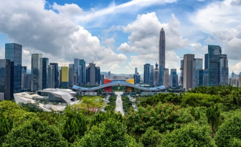 Landscape in China with greeneries, high buildings and a blue sky.