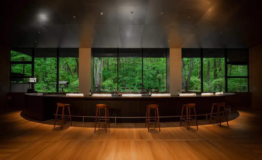 Suntory Yamazaki Distillery Tasting Lounge, a bar with bottles and windows with sightseeing view on forests