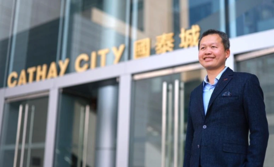 A man in front of a building Cathay City