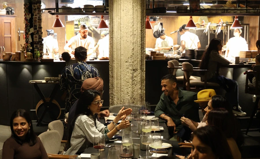 Indian people having dinner in a restaurant named Hearth