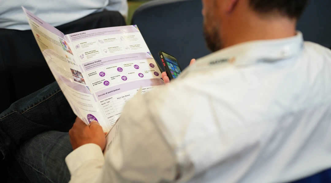 A man who is reading a brochure during a session at Vinexpo Asia in Hong Kong