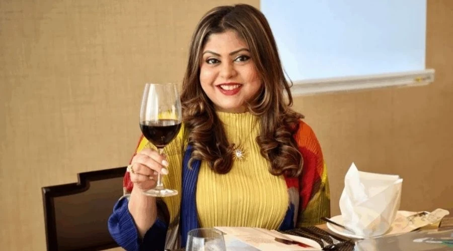 personne avec un verre de vin rouge à la main