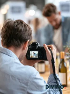 man taking picture of someone working on his stand on an exhibition
